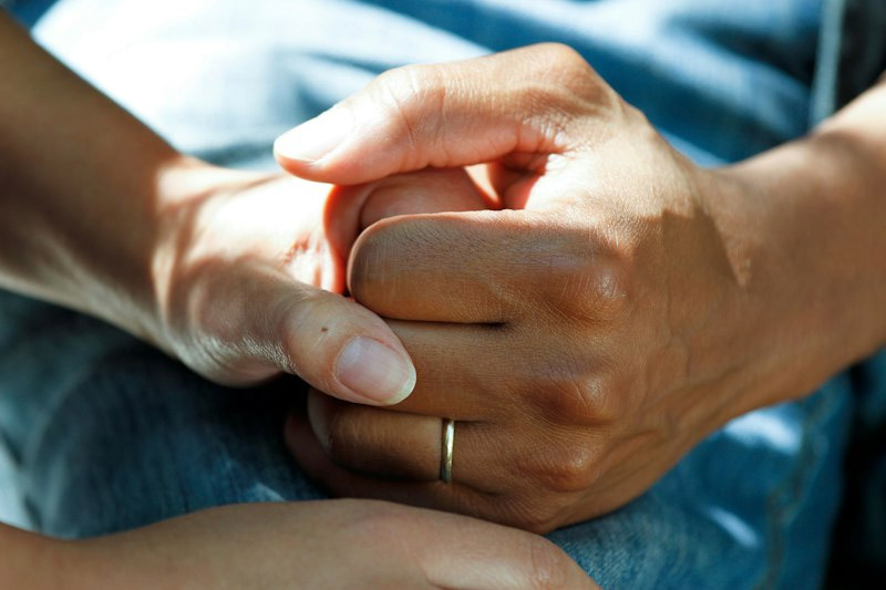 Dermatologist examining patient skin — consultation trust